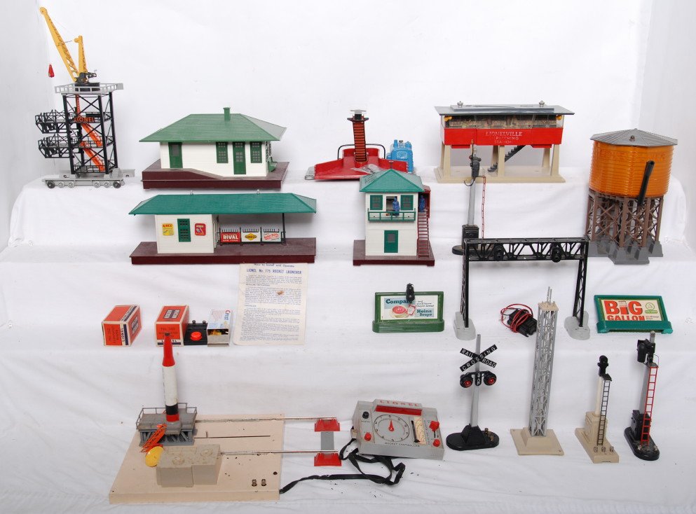 Lionel Postwar accessories 175, 445, 30, etc: Lionel Postwar O gauge accessories. Includes 175 rocket launcher, 30 water tower, 445 switch tower, two 260 bumpers in OBs. 133 illuminated station, 256 freight station, 365 dispatch station missing m
