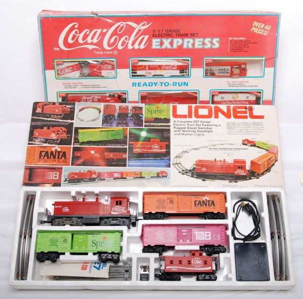 Lionel and K Line Coca Cola sets: Lionel and K Line modern O gauge Coca Cola sets in OBs. Includes K-1111 set in C7-8 condition with worn set box, and Lionel 1463 set. Set is C7 with some very light spots of frame rust. OB has split l