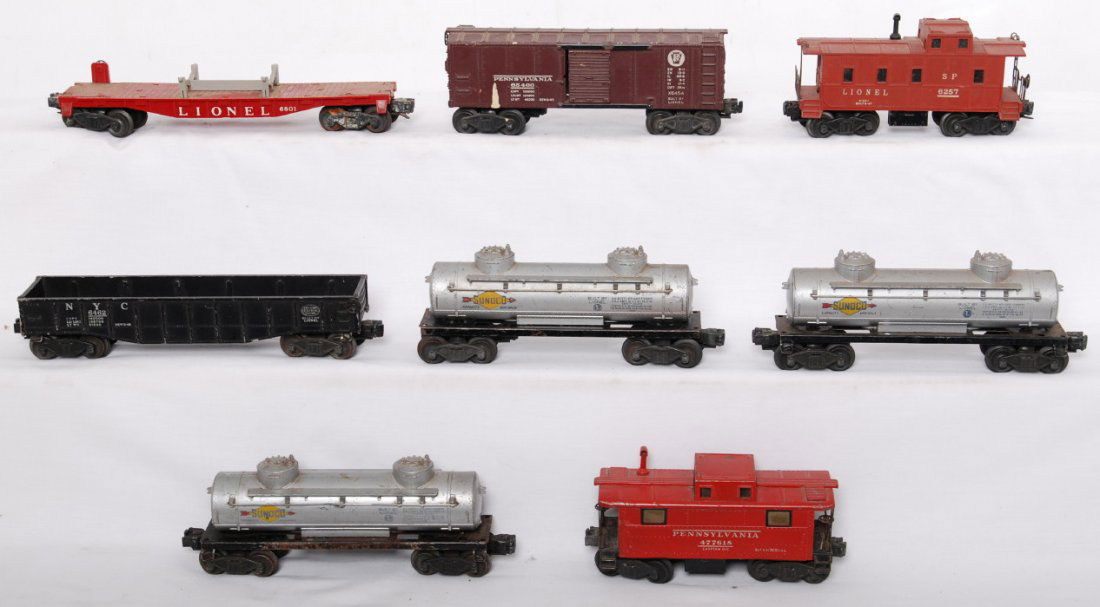 Eight Lionel postwar O gauge freight cars: Postwar Lionel O gauge freight cars, C5-6. 6462 NYC gondola, 6454 Pennsylvania boxcar, three 6465 Sunoco tank cars, 6801 flatcar, 6257 SP style caboose, and 2457 Pennsylvania caboose.