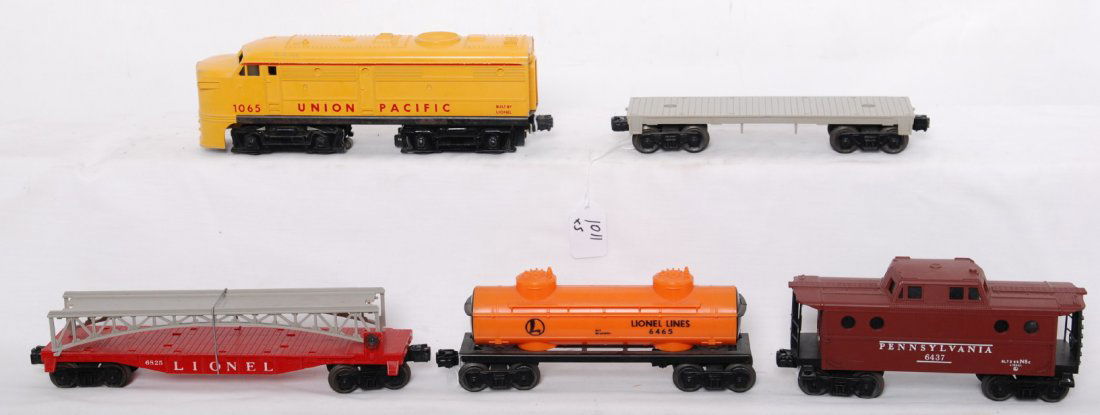 Lionel 1065, 6825, flatcar, 6465, 6437: Postwar Lionel O gauge 1065 Union Pacific diesel Alco A unit, 6825 flatcar w/bridge section, unnumbered flatcar, 6465 tank, and 6437 Pennsylvania caboose, C6 area.