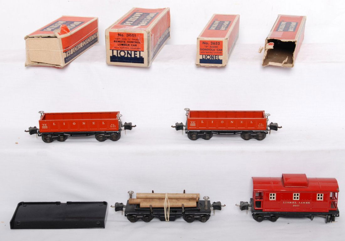 Lionel 2652, 2652, 2657, 3651 in OB: Postwar Lionel O gauge freight cars in OB, C6-7. Boxes have missing flaps. Two 2652 gondolas, 3651 remote control lumber car, and 2657 caboose.