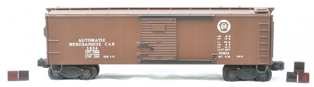 Lionel 3854 Automatic Merchandise Car w/Cubes: Lionel postwar 3854 Automatic Merchandise Car with a PRR logo and five cubes. The car has been professionally restored to look like new.