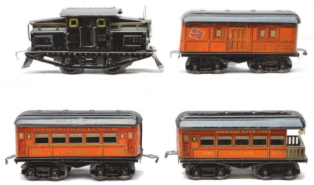 AF 1218 Steeple Cab Loco CM&StP 1205 1206 1207: American Flyer prewar O gauge 1218 black 0-4-0 electric steeple cab loco with three lithographed orange Chicago Milwaukee and St. Paul eight wheel passenger cars with black roofs; 1205 baggage, 1206 S