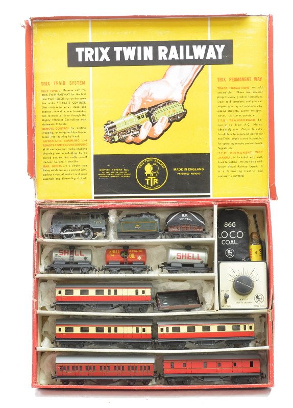Trix Twin Railway Litho Goods/Passenger Set: Trix Twin Railway made in England OO gauge lithographed goods/ passenger set in OB with original cardboard inserts containing; loco, tender, open wagon, covered wagon, three Shell tanks, three red/cre