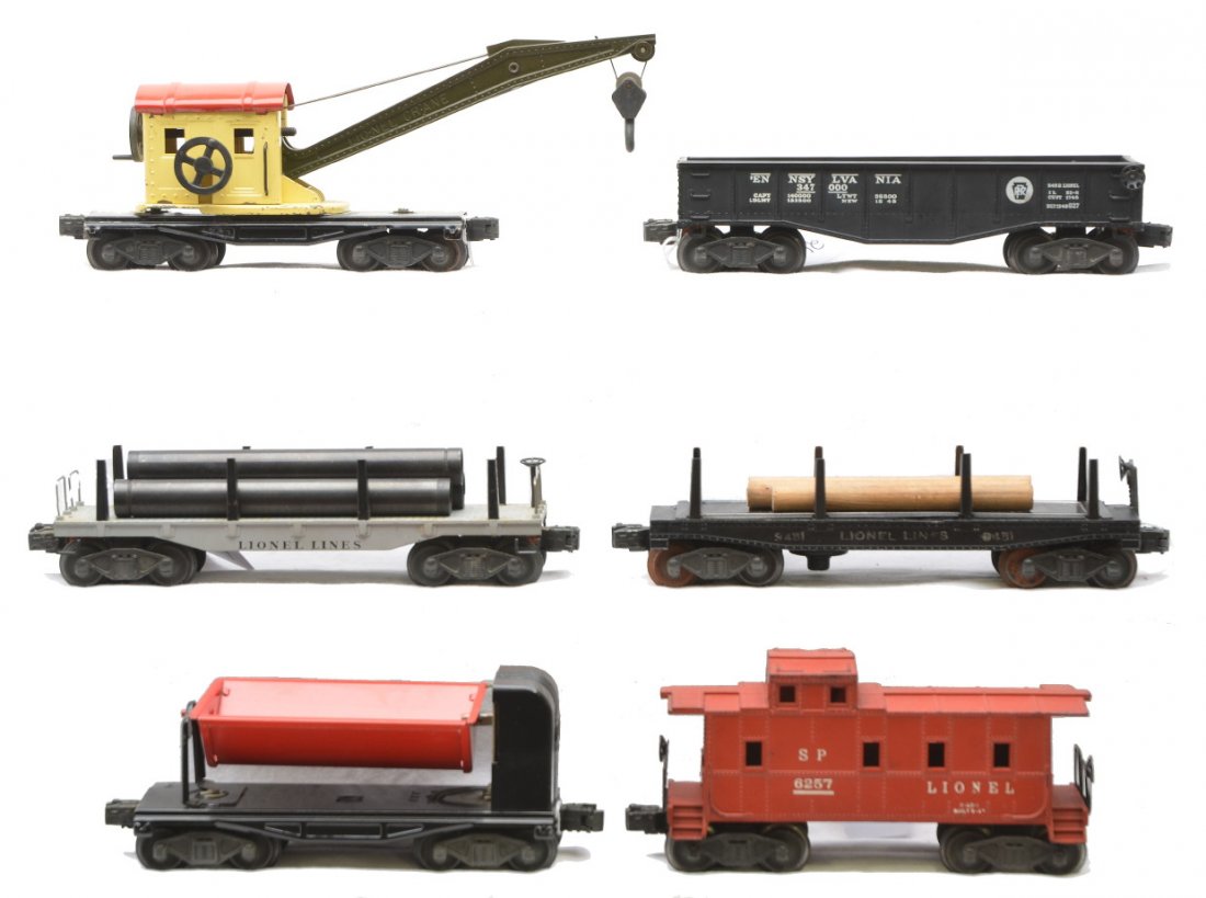 Lionel Freights 2411 3451 2452 2560 3559 6257: Lionel postwar freight cars including; 2411 pipe car, 3451 log car with instruction sheet, 2452 Pennsylvania gondola, 2560 crane car with cream cab, red roof and dark olive boom, 3559 dump car with a 