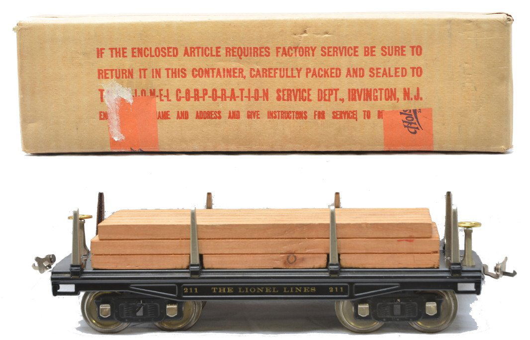 Lionel Prewar 211 Lumber Car LN Boxed: Lionel prewar standard gauge 211 flatcar with lumber load, brass brake wheels and nickel journals in OB. One stake on the car has rust, otherwise car is C8. The OB is clean with all flaps attached.