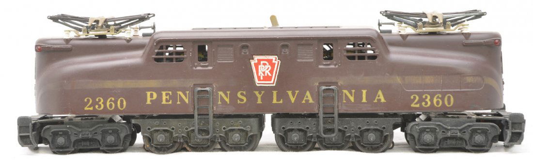 Lionel 2360 Tuscan PRR GG1 w/Solid Stripe: Lionel postwar 2630 Tuscan Pennsylvania GG1 electric diesel with solid gold stripe, rubber stamped lettering and large PRR decal. The solid stripe is faded and the decal has cracks, other than that th