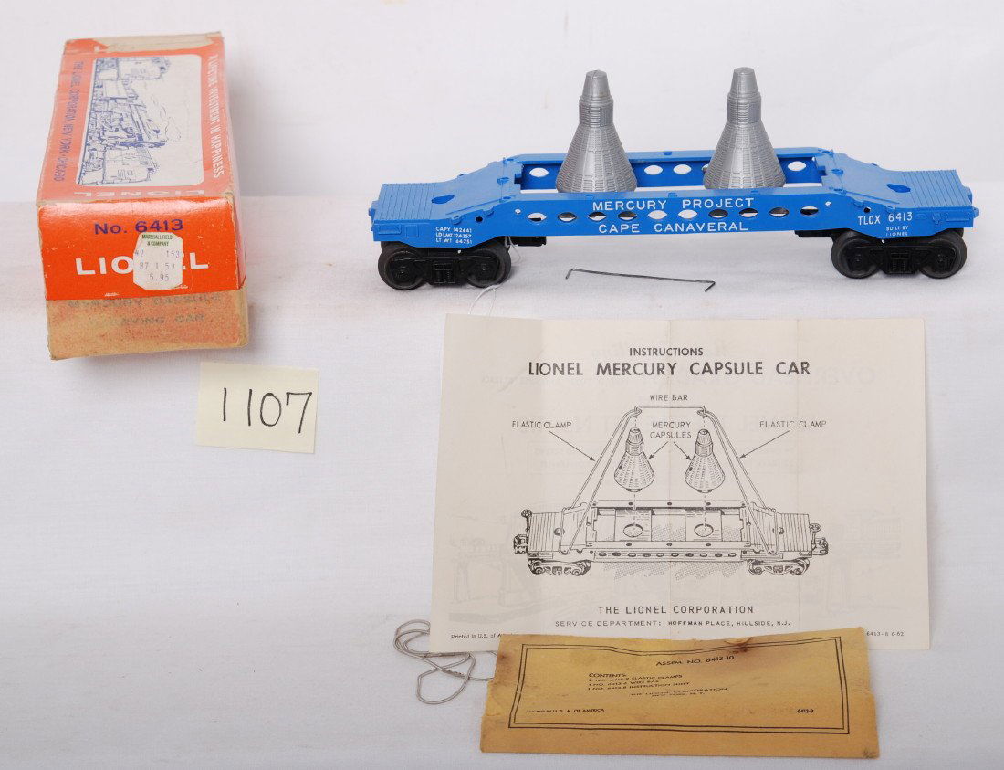 Lionel 6413 Mercury capsule car in OB w/comp.: Postwar Lionel O gauge 6413 Mercury Capsule car, darker blue variation with capsules, components envelope, elastic clamps, wire bar, and instructions sheet in original box, unrun C8 area. Box has mask