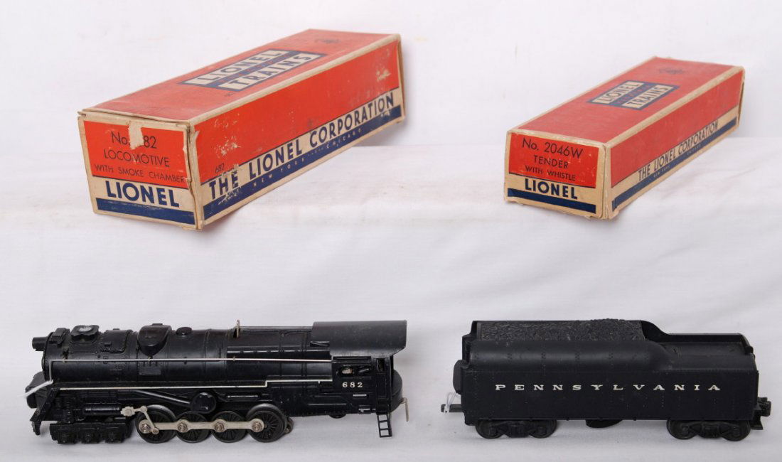 Lionel 682 steam locomotive & 2046W tender in OB: Postwar Lionel O gauge 682 steam locomotive with smoke chamber and 2046W Pennsylvania whistle tender. Loco needs rear truck repaired or replaced. Trains should clean to look C6-7. Loco box has insert,