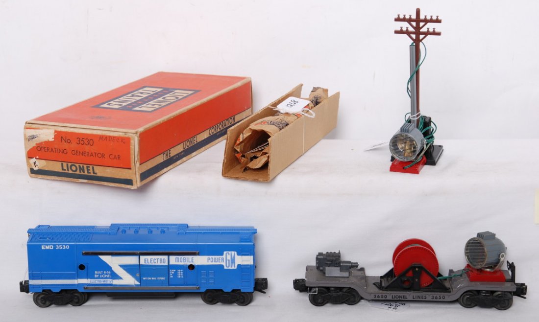 Lionel 3530 in OB w/insert.... and 3650 drk. gray: Postwar Lionel O gauge 3530 GM EMD generator car with full stripe and black fuel tank in original box with insert, wrapping paper, and instructions sheets, shell has hairline at screw and specks of ru
