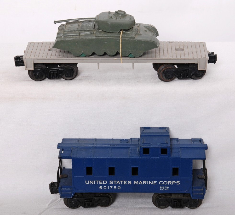 Lionel unnumbered 1877 flat w/Payton tank & 6017-: Postwar Lionel O gauge unnumbered 1877 body mold unnumbered flatcar with Payton Plastics tank. Flatcar should clean unrun C6-7. Unmarked tank is olive drab. 6017-50 United States Marine Corps caboose,