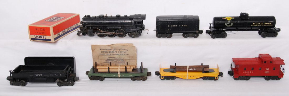 Lionel 1666, 2689TX, 2855, 3469, 3461, 6111, 6257: Postwar Lionel O gauge 1666 steam locomotive, 2689TX tender without whistle, 2855 Sunoco tank, 3469 automatic dump car, 3461 automatic lumber car, 6111 pipe/log car, and 6257-25 illuminated caboose. L