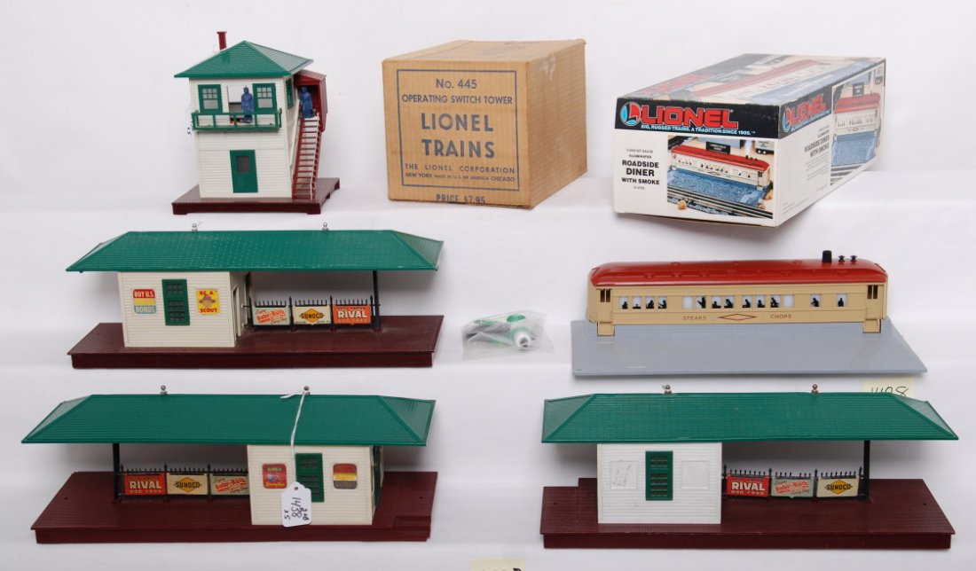 Lionel 445 in OB, 12722 in OB, 256 x2, 257: Postwar Lionel O gauge 445 operating switch tower in original box, modern era O gauge 12722 illuminated road side diner with smoke in original box, two postwar O gauge 256 freight stations, and postwa