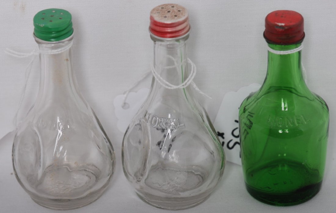 Lionel bottles, salt & pepper, vinegar: Three small clear glass bottles with metal caps. One was supposedly for salt, one for pepper, and the green one was supposedly for white vinegar. All three bottles have LIONEL embossed on them. These 