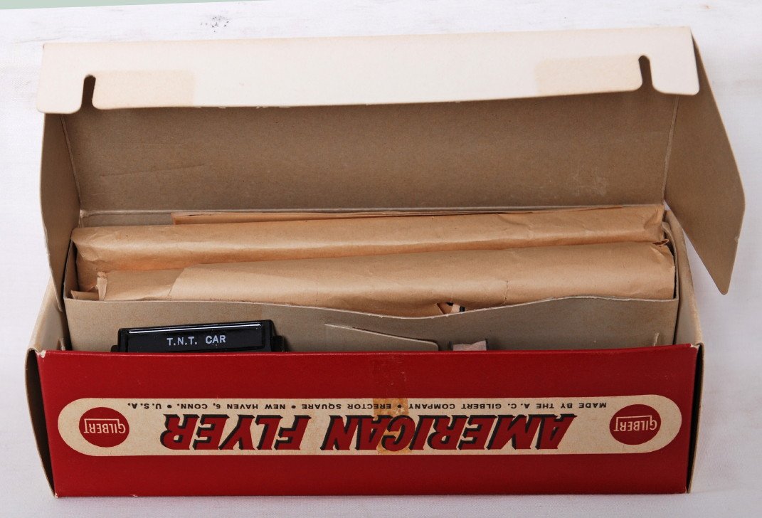 American Flyer 25061 TNT car in OB: American Flyer postwar S gauge 25061 operating TNT car in OB. Car is C9 area with the box open, but the parts appear to be factory wrapped. Instructions, button, power rail, and car included. Box is a