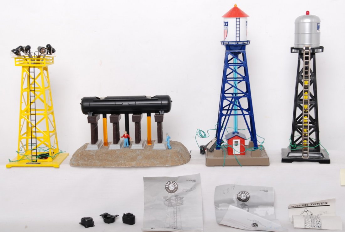 Lionel and K Line water towers and floodlights: Lionel modern O gauge accessories. Includes 24102 bubbling water tower, bubbling oil storage tank with tank domes loose, modern 395 floodlight tower, and K Line DairymenÕs bubbling water tower. C7-8