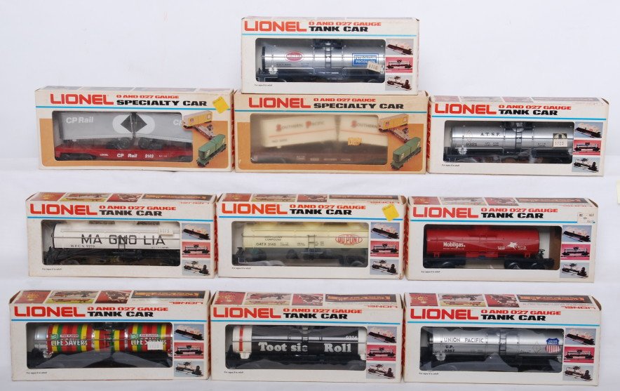 10 Lionel tank cars and flats with vans 9278, 9324: Lionel modern O gauge freight cars in OB. Ten freight cars include 9149 CP Rail flat with vans, 9333 Southern Pacific flat with vans, 9279 Magnolia tank, 9321 Santa Fe tank car, 9039 Mobile tank car, 