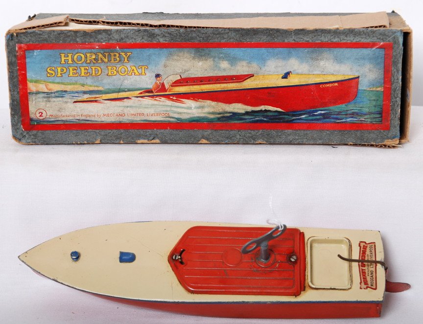 Hornby Speed Boat No. 2 Swift in OB: Postwar Hornby Speed Boat No. 2 Swift mechanical speed boat in partial original box with key. Boat looks C7. Box has restoration to partial lid and bottom.