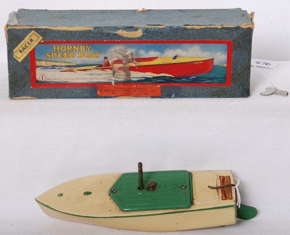 Hornby Speed Boat No. 1 RACER 1, in OB: Postwar Hornby Speed Boat, Hornby Racing Boat No. 1, ÒRACER 1Ó, in original boat. Working motor. Boat looks C7. Box has split corner, tape repaired hole in lid, tap repairs to bottom. Box has tested