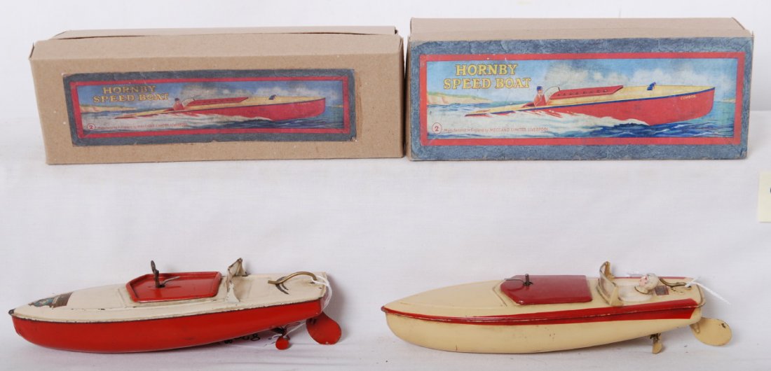 Two Hornby Speed Boat No. 2 in OB Corination: Postwar Hornby Speed Boat No. 2 in original box. One has driver and no key, C7. Other has Coronation decal on bow of boat with key, C6. Both motors operate well. Boxes show little wear.