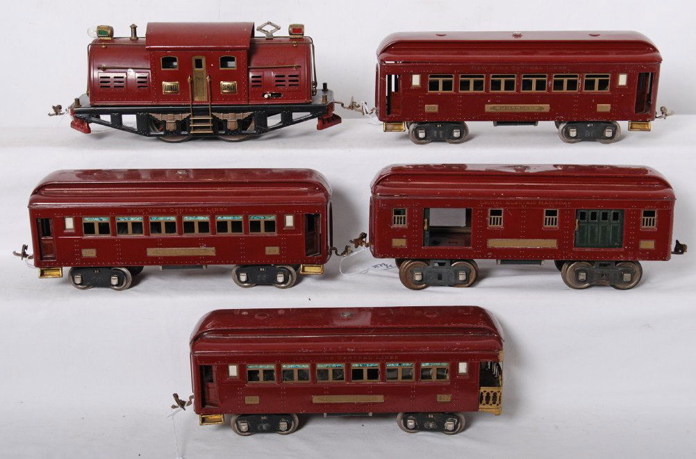 Lionel 380, 319, 319, 320, 321 red passenger set: Prewar Lionel standard gauge red passenger train with 380 center cab electric locomotive, two 319 Pullman coaches, 320 Railway Mail car, and 321 observation. Loco has dinged roof overhang and repainte
