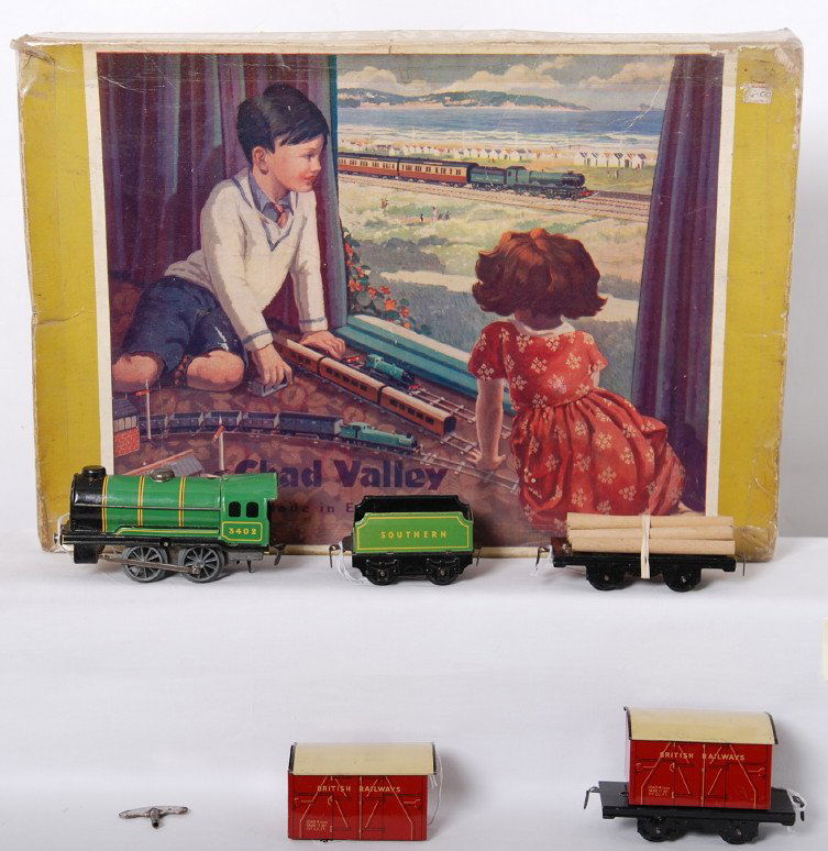 Chad Valley clockwork train set and lines, in ori: Postwar Chad Valley, Made in England Clockwork Train Set and Lines, mechanical train in original box with track. Set is comprised of a 3402 Southern steam locomotive and tender with two flatcars that