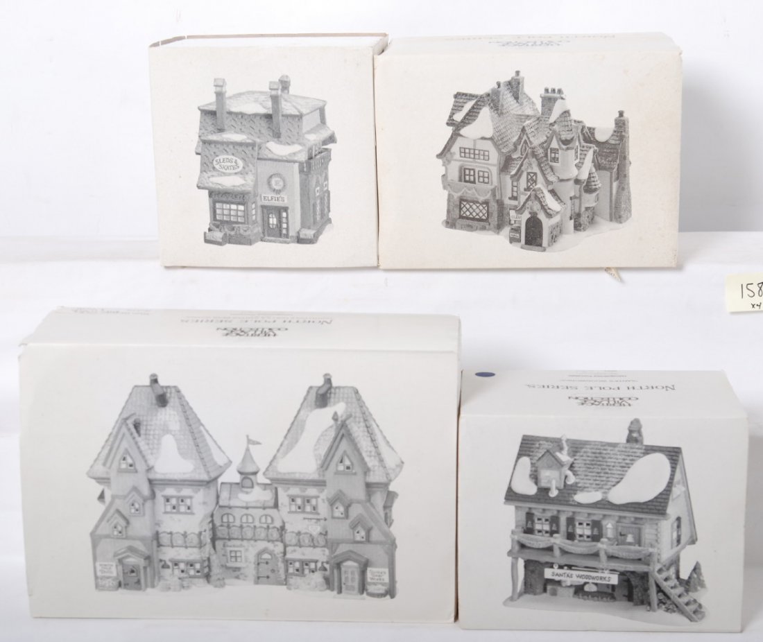 4 Department 56 North Pole Series buildings: Department 56 North Pole Series buildings in OBs. Four buildings include 5625-1 ElfieÕs Sleds, 5628-6 SantaÕs Woodworks, 5635-9 North Pole Dolls, and 5600-6 SantaÕs Workshop. Buildings appear to be