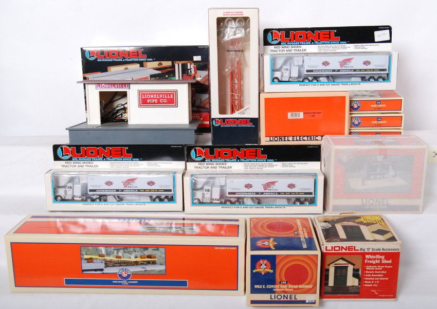Large group of Lionel accessories 12955, 32996, e: Large group of modern O gauge accessories. Lionel items include three 14071 yard light packs, 12955 Road Runner shack, 32996 barrel loader, 14085 newsstand, 2126 whistling shed, 12862 oil drum loader,
