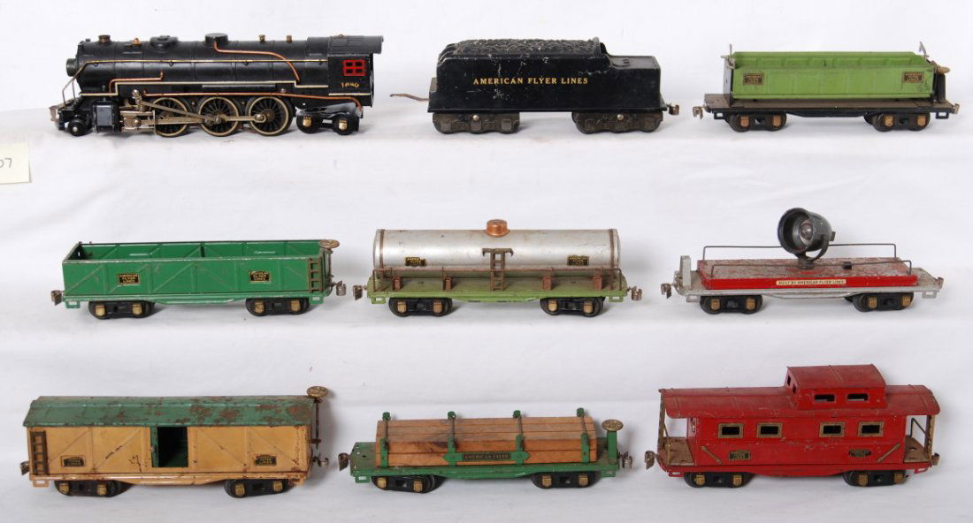 American Flyer prewar 1680, 3213: American Flyer prewar O gauge trains. Includes 1680 2-6-4 steam locomotive and tender, searchlight car, caboose, reefer, green flat with lumber, gondola, apple green dump gondola, and tank car. See ph