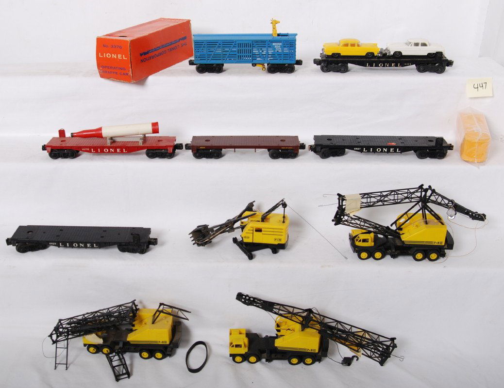 Lionel 3376, P&H shovels, 6424, 6175, etc: Lionel Postwar O gauge including, 3376 operating giraffe car in OB with one detached flap and one missing inner flap, 6426 auto flat, 6175 flat with original rocket, three P&H cranes, P&H shovel, 6828
