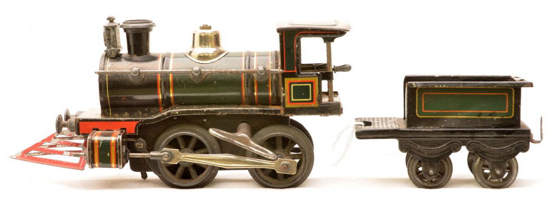 Carette Made for American Market Steam Loco: Carette O gauge made for the American market black clockwork 0-4-0 outline steam loco with a four wheel lithographed tender, circa 1908-14. This loco has a forward and reverse with brake levers. Loco
