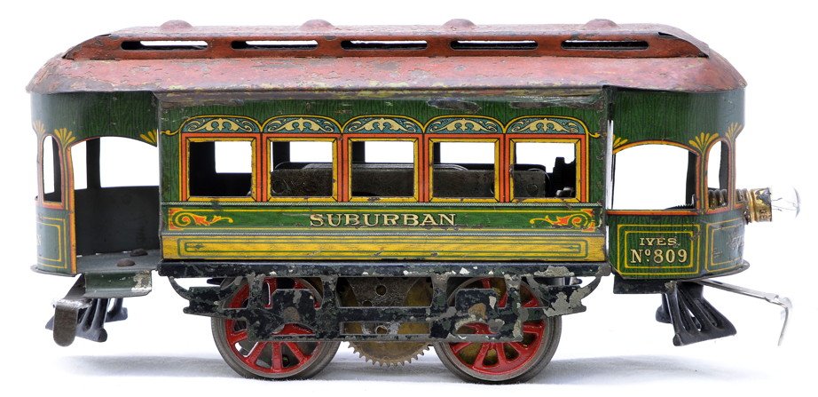 Ives no. 809 Litho Electric Powered Street Car: Ives prewar O gauge no. 809 lithographed electric powered street car, circa 1913-16 lettered Suburban on each side and each end. The roof has heavy paint flaking and is orange. The roller assembly has