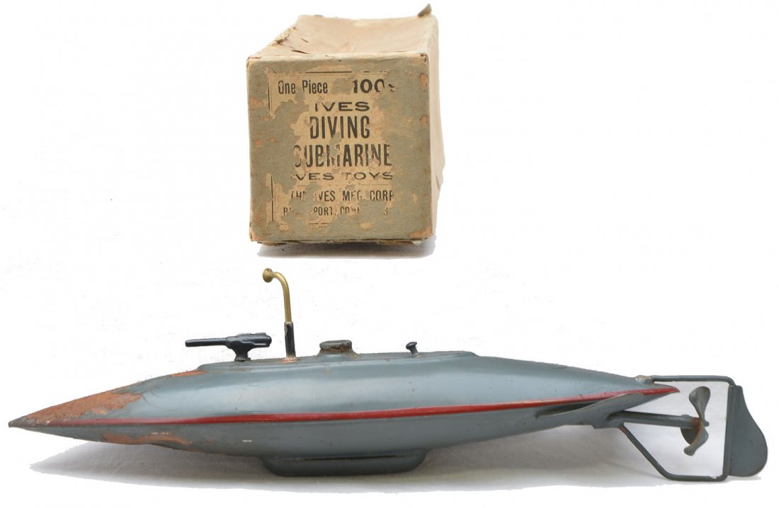 Ives no. 1009 Clockwork Diving Submarine OB: Ives no. 1009 clockwork diving submarine with key in OB. The paint has flaked on two sections of the submarine and has surface rust. Submarine is C5. The OB is complete with all flaps and label is par