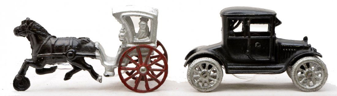 Cast Iron Horse Drawn Buggy & Ford Model T Auto: Cast iron horse drawn silver buggy with red wheels. Also included is a cast iron black Ford Model T automobile with silver tires. The cast iron toys are C7-8.