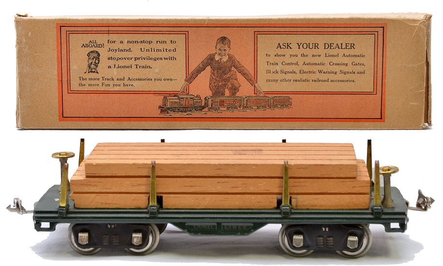 Lionel Std. Ga. 511 Dark Green Flatcar w/Wood: Lionel prewar standard gauge 511 dark green flatcar with wood load, brass trim and nickel journals, C7. The OB has flaps attached with tape repair.