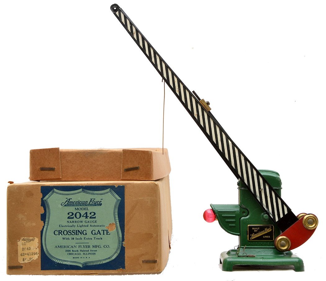 Am Flyer 2042 Die Cast Crossing Gate Boxed: American Flyer prewar narrow gauge 2042 die cast crossing gate in OB with original cardboard insert. The die cast base is solid and intact. The crossing gate is C7. The OB has no split corners and the