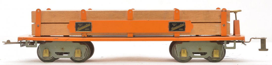 Am Flyer Prewar Wide Ga. 4023 Orange Log Car: American Flyer prewar wide gauge 4023 orange log car with orange side bars, four brass plates that read Built by American Flyer Lines, gray set trucks and brass journals. The car is C7.