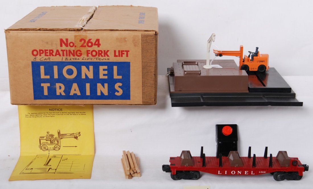 Lionel 264 operating fork lift in OB w/insert....: Postwar Lionel O gauge 264 operating fork lift accessory in original box with insert, 90C, timbers, instructions sheet, unused C8 with unrun 6264 lumber car C9. Box has some writing on end panels, and