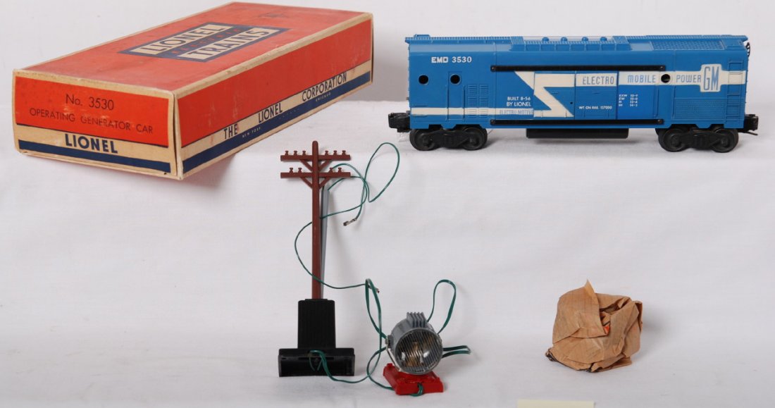 Lionel 3530 EMD GM operating generator car in OB w: Postwar Lionel O gauge 3530 EMD GM operating generator car in original box with insert, pole and light, and wrap. Train has some rust starting to speck on a door guide, otherwise C9 area, full stripe