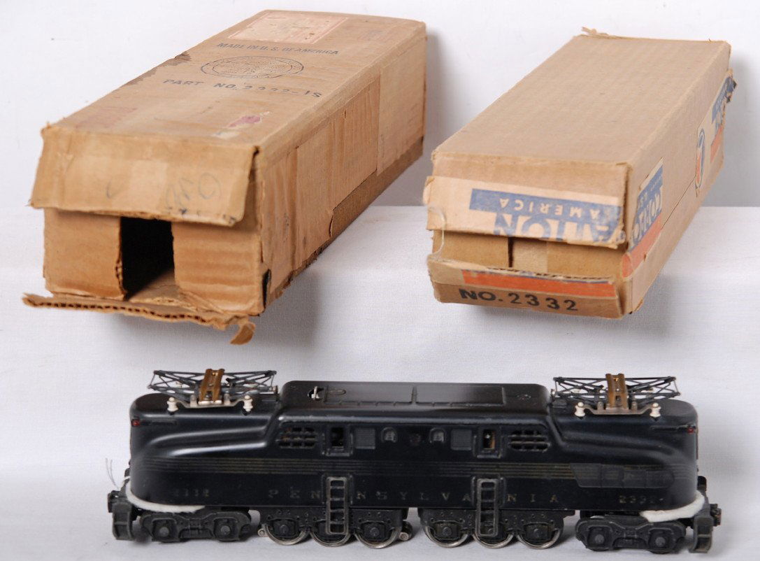 Lionel 2332 black GG-1 electric locomotive in OB: Postwar Lionel O gauge 2332 black GG-1 electric locomotive with red armature cover and rubber stamped heralds, little touchup near a ladder, O/W nicer C6. Shipping carton has some deterioration to a s