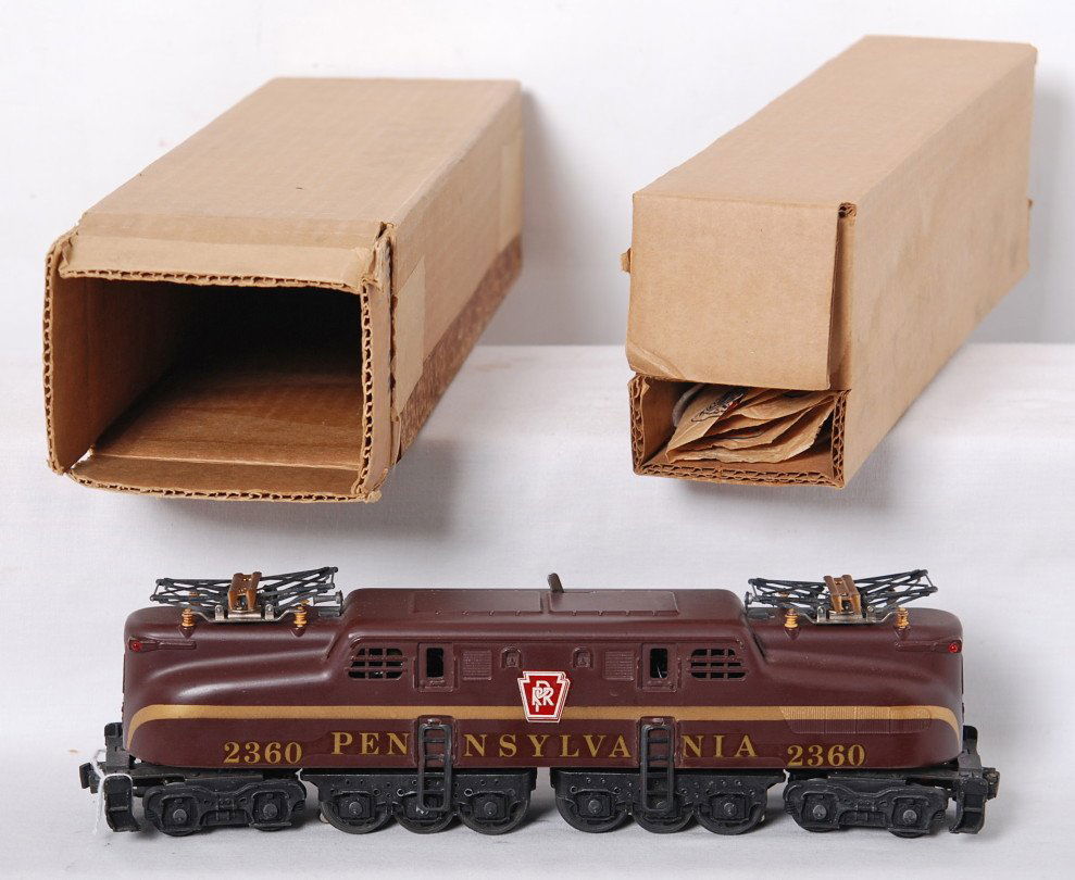 Lionel 2360 Tuscan single stripe PRR GG-1 in OB: Postwar Lionel O gauge 2360 Tuscan single stripe Pennsylvania GG-1 electric locomotive in original box with insert and wrap. At first glance loco looks fantastic, but has tiny nicks along edges with t