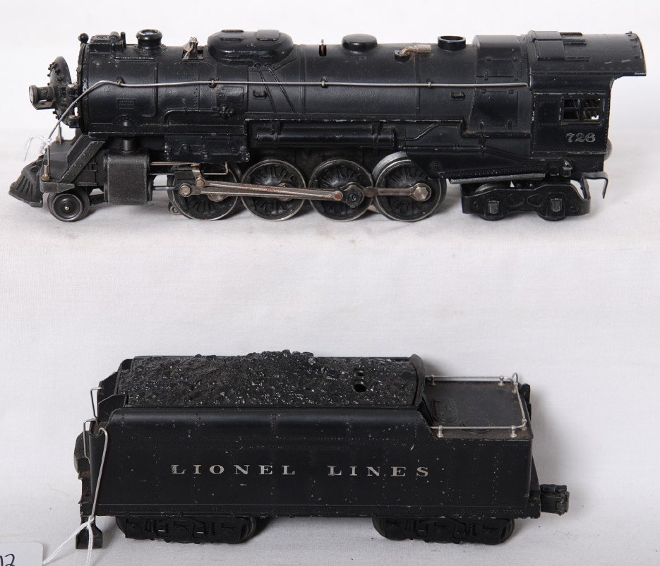 Lionel 726 steam loco and 2426W whistle tender: Postwar Lionel O gauge 726 steam locomotive and 2426W whistle tender. Loco is missing a marker light. Tender is missing front coupler, step, cracked coal load. Trains are sold as is with no returns. V
