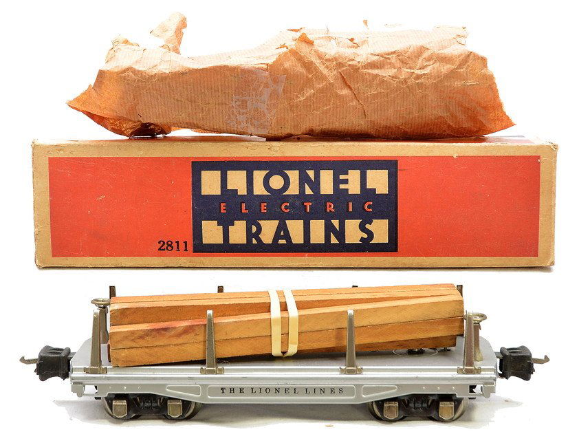 Lionel 2811 Aluminum Flatcar w/Lumber Load: Lionel prewar O gauge 2811 aluminum flatcar with lumber load, nickel trim and journals in OB that has original paper wrap. Car is C8. The OB has all flaps attached with some repaired flaps.