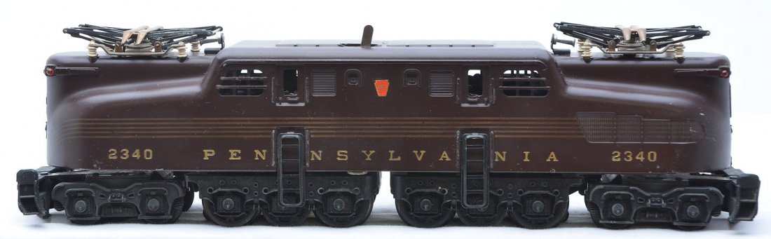 Lionel 2340 Tuscan Pennsylvania GG1 Diesel LN: Lionel postwar 2340 Tuscan Pennsylvania GG1 diesel. The diesel has light run time. The stampings on the engine are strong. The GG1 is C8.