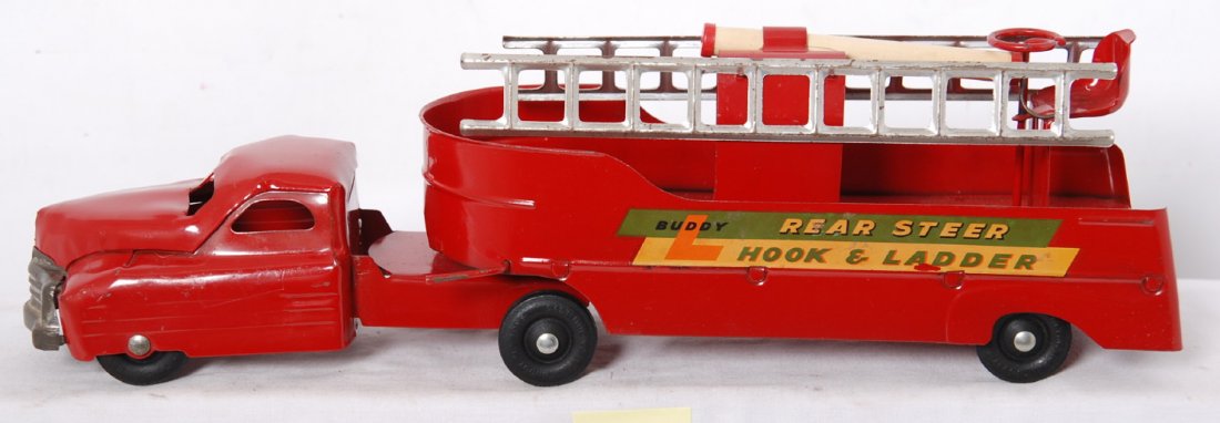 Buddy L Rear Steer Hook and Ladder pressed steel: Buddy L pressed steel Rear Steer Hook and Ladder fire truck with ladders and water pump, light oxidation/surface rust, O/W C7. Truck measures approximately 20 inches long.