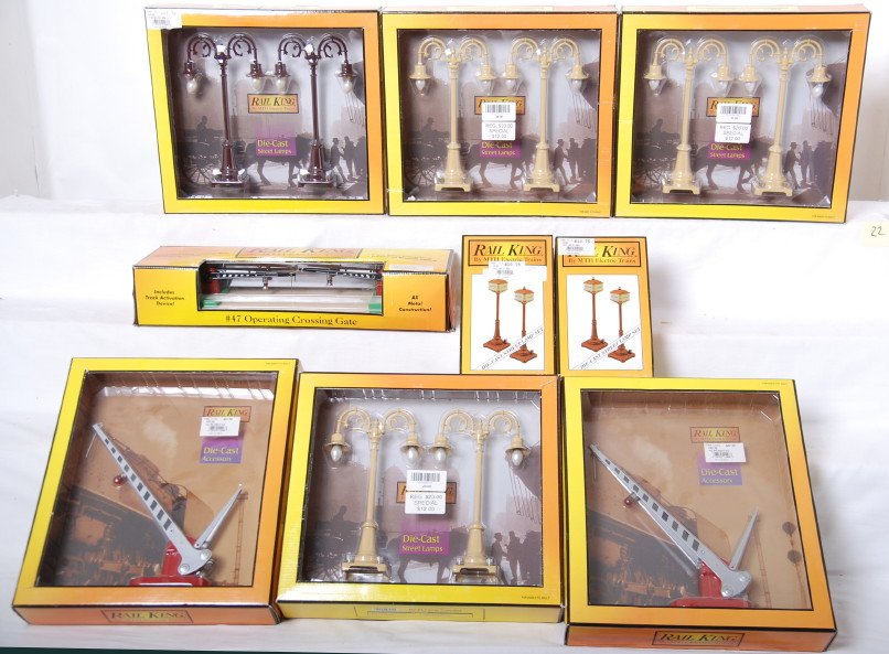 10 Railking prewar style crossings and lamps: MTH Railking modern O gauge prewar style signals and lamps in OBs. Includes 1080 crossing gate, 1036 warning bell, two 11008 crossing gates, three 1096 lamp post sets, 1066 lamp post set, and two 1029