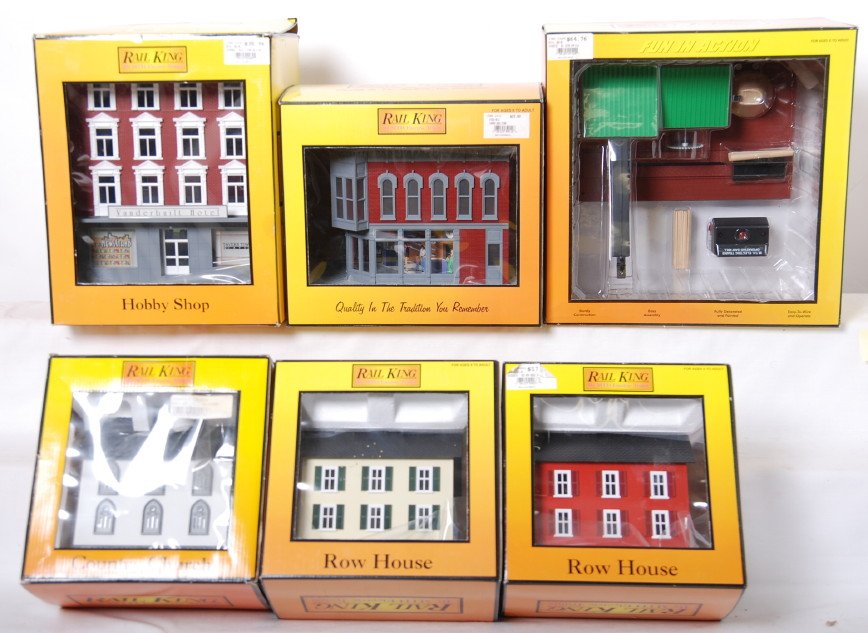 6 Railking buildings and accessories: MTH Railking modern O gauge accessories and buildings in OBs. Includes 9082 hotel, 9012 drug store, 9076 row house, 9023 row house, 9122 operating saw mill, and 9002 church. C9-10 OBs have some light 