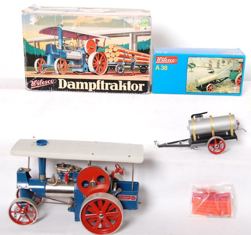 Wilesco D40 in OB and A38 water cart in OB steam: Wilesco D40 Old Smoky traction-engine, steam powered toy in original box with components sealed in bag. Toy has never been fired but has some specks of rust at some paint nicks (looks like from assemb