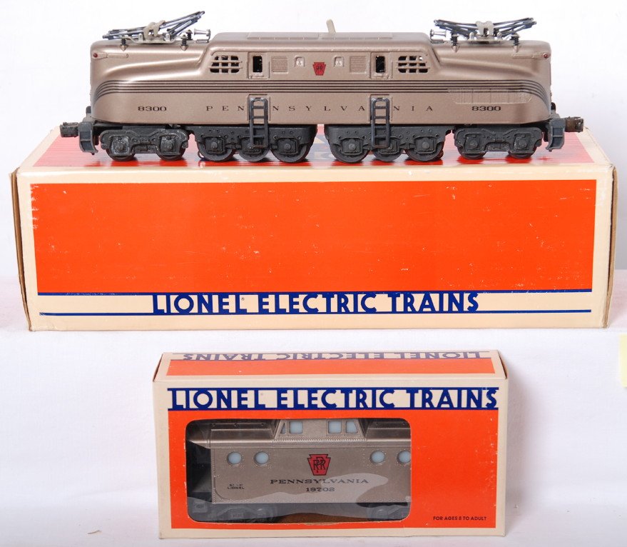 Lionel PRR Mint Series 18300 GG-1 and caboose: Lionel modern O gauge Pennsylvania Mint Series; 18300 GG-1 diesel loco in OB. The loco is C7+ with two small scuffs on the roof. Caboose is C7-8. Both OBs have some shelf wear.