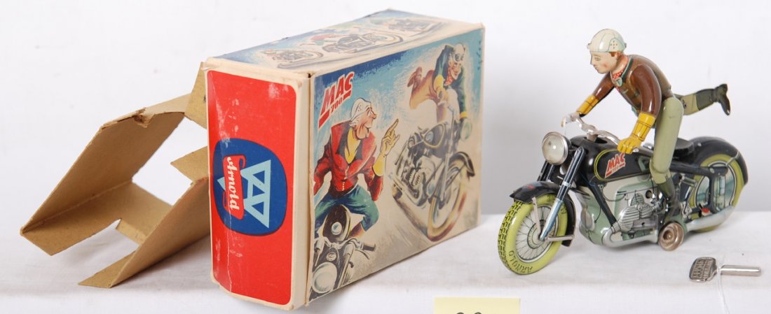 Arnold Mac 700 keywind mechanical motorcycle in: Vintage Arnold Toys Mac 700 keywind mechanical motorcycle stunt rider toy with key in original box. Toy has some small spots of rust on a few parts, mostly at silver and unpainted, so some may clean.